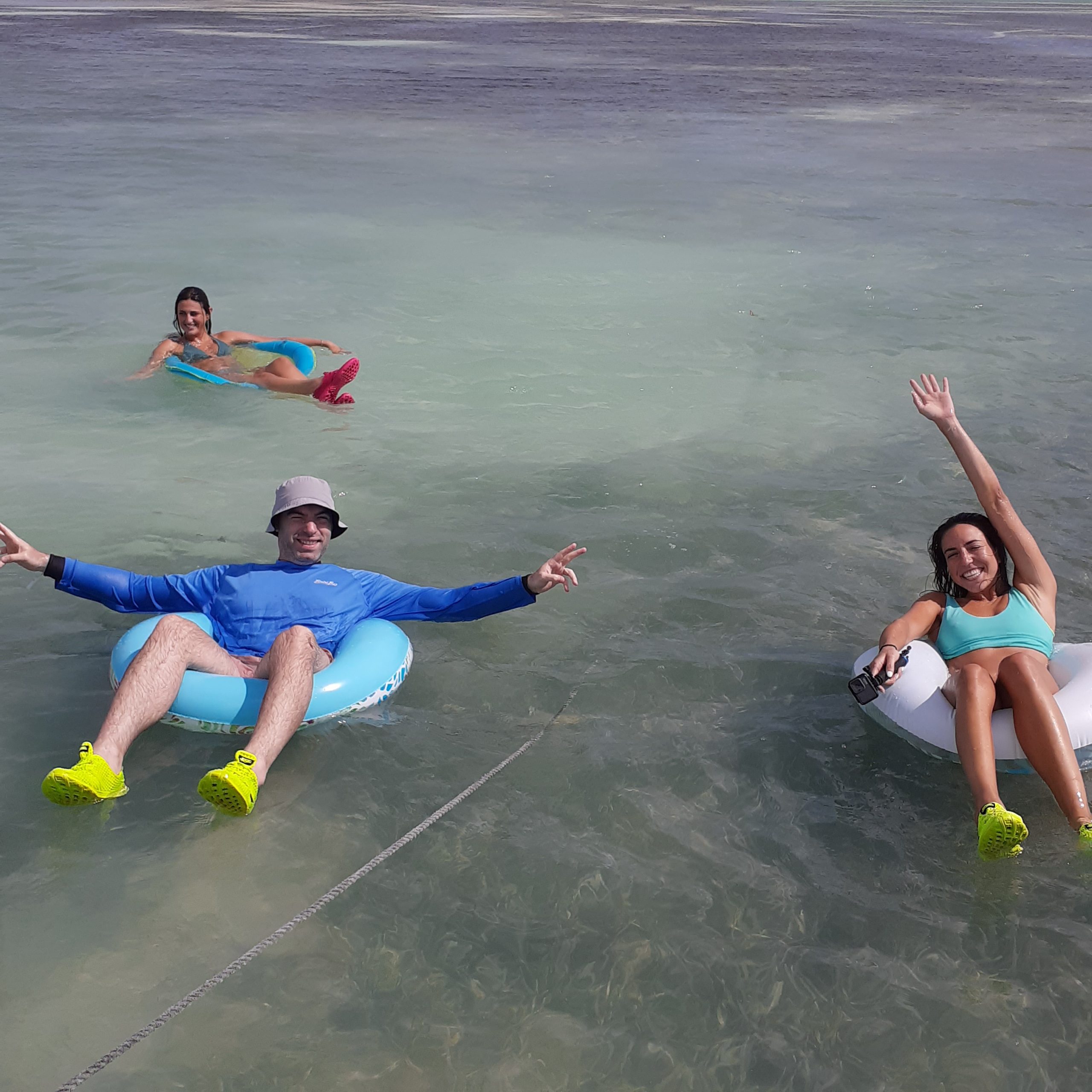 three people floating in the water in Islamorada Sandbar