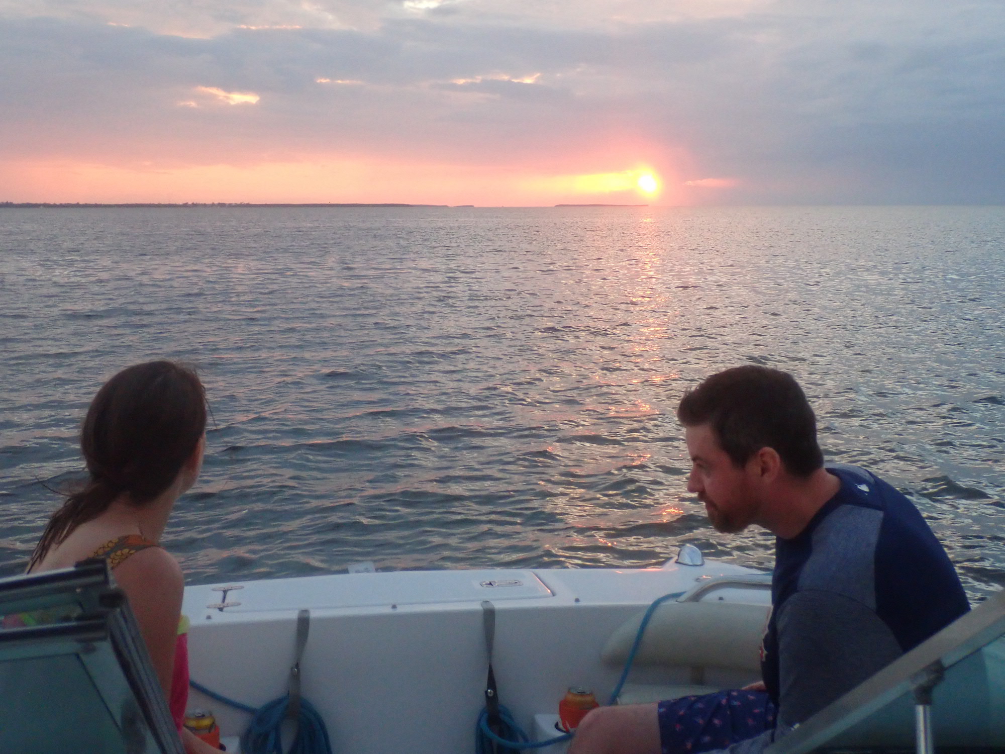 Sunset cruise, two people on the boat watching the sunset