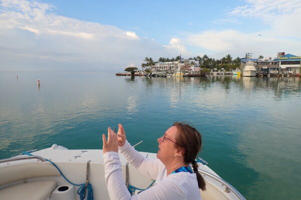 woman on a boat around islamorada taking pictures